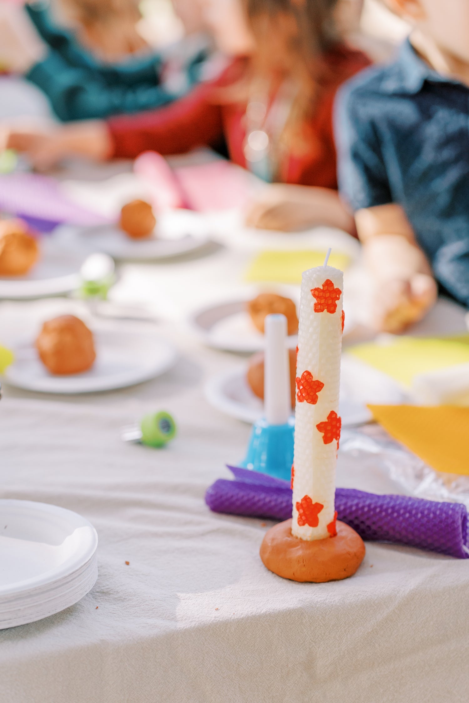 Children's play area with colorful toys and a candle on a table.
