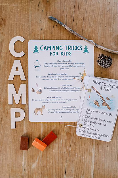 Image of a card with wooden letters spelling c.a.m.p.