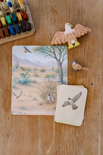 Image of a card on a table with toy birds.