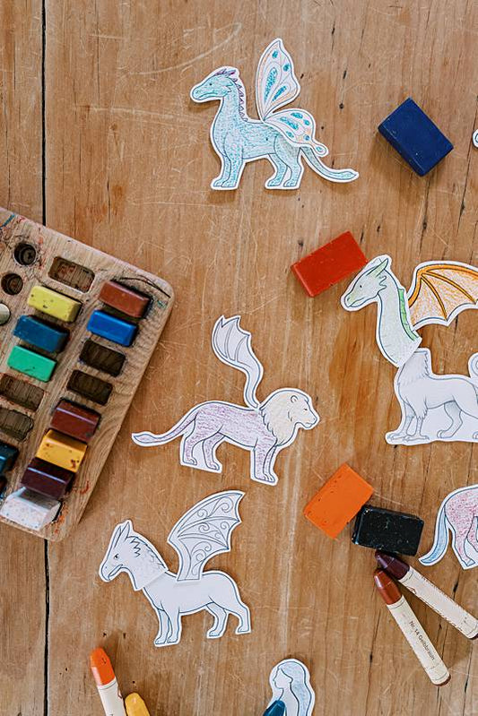 Cut out dragon toys laying on a wooden table