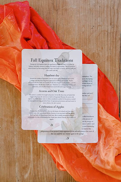 cards laying on a play silk on a wooden table