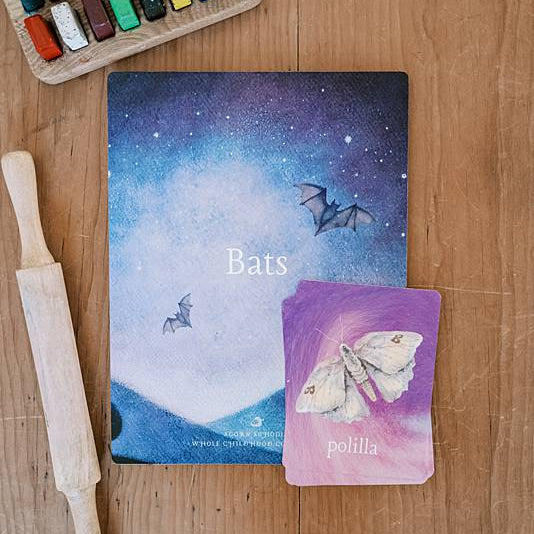 Cards laying next to crayons and a rolling pin.