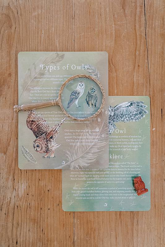 Two cards on a table with a magnifying glass
