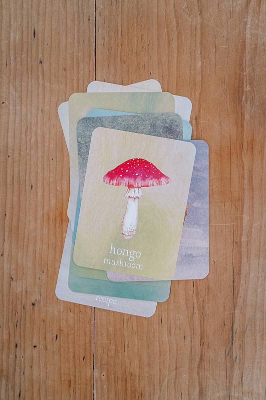 Cards on a wooden table with mushroom illustrations