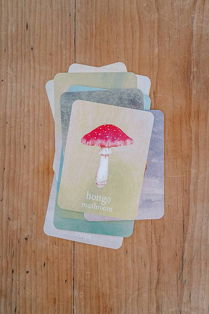 Cards on a wooden table with mushroom illustrations