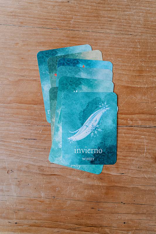 small cards in a pile on a wooden table