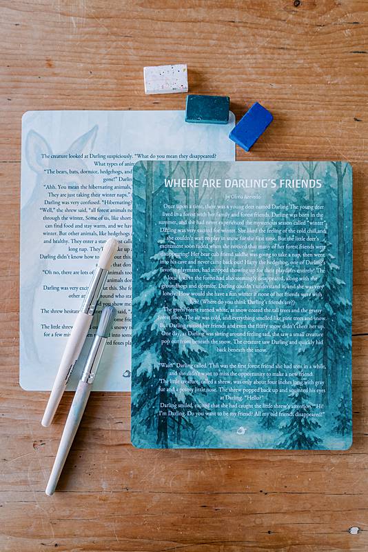 Two large cards with paint brushes and crayons
