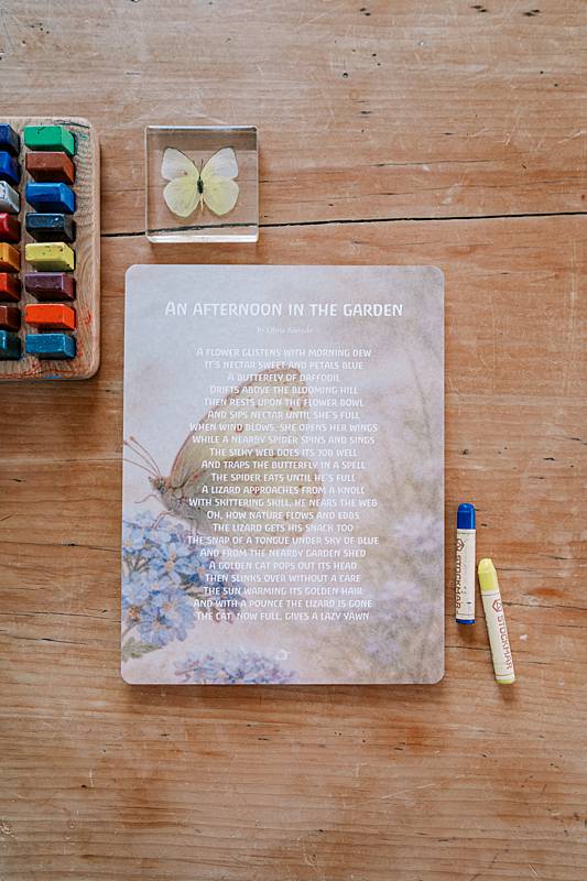 Large paper on a table with crayons and a butterfly toy
