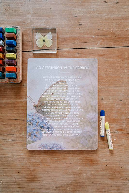Large paper on a table with crayons and a butterfly toy