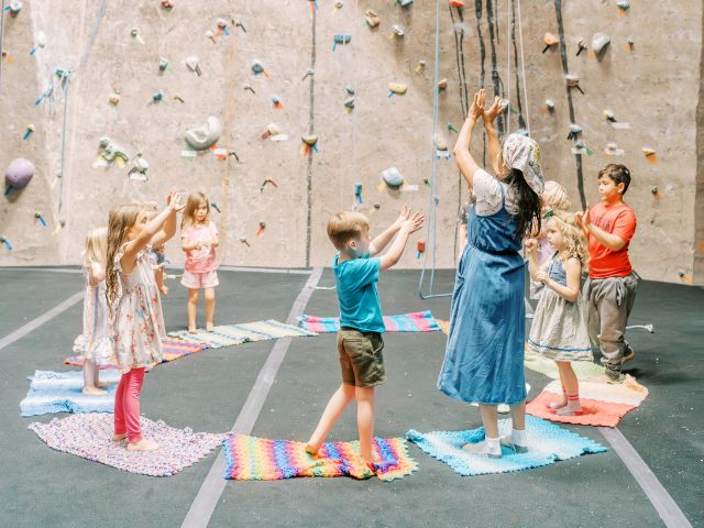 Children doing circle time at ClimbMax during an Acorn School class.