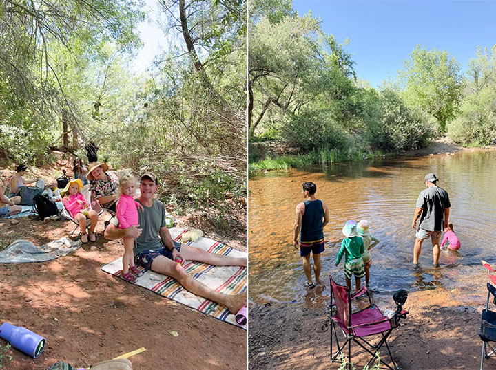 Children with their parents having a picnic alongside children playing in a river with their dads. 