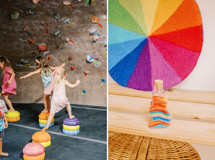 Children running on stacking toys in a rock gym alongside a bottle with colorful sand inside it. 