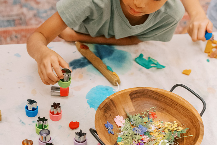 A child working with crafts on a table. 