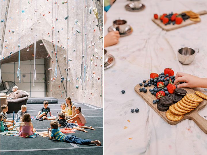 n sitting in a circle inside a rock gym alongside a snack table with children's hands.
