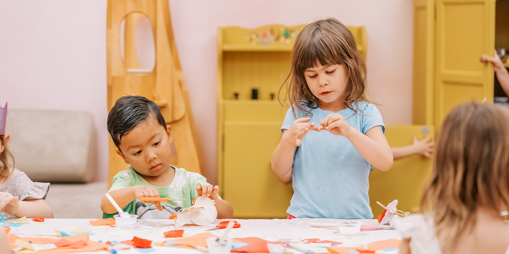 Children crafting at a table